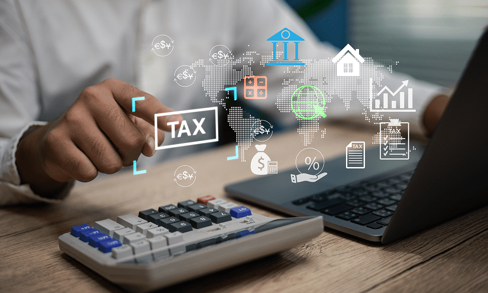 Hand using calculator for tax analysis