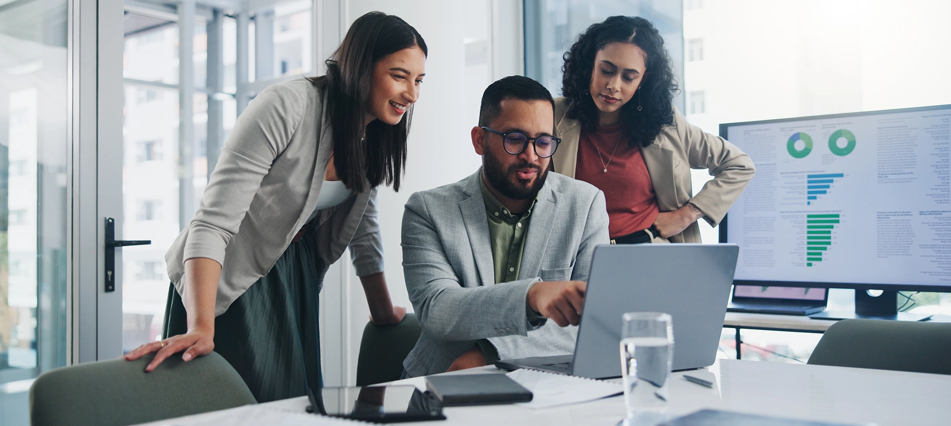 Team reviewing data on laptop screen