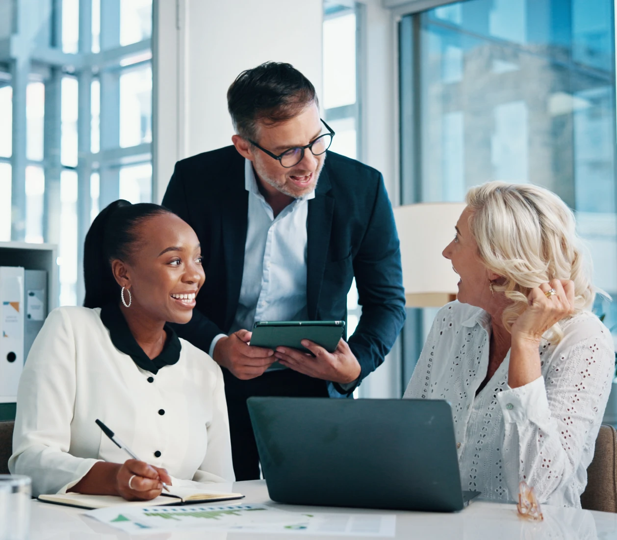 Colleagues collaborating with smiles